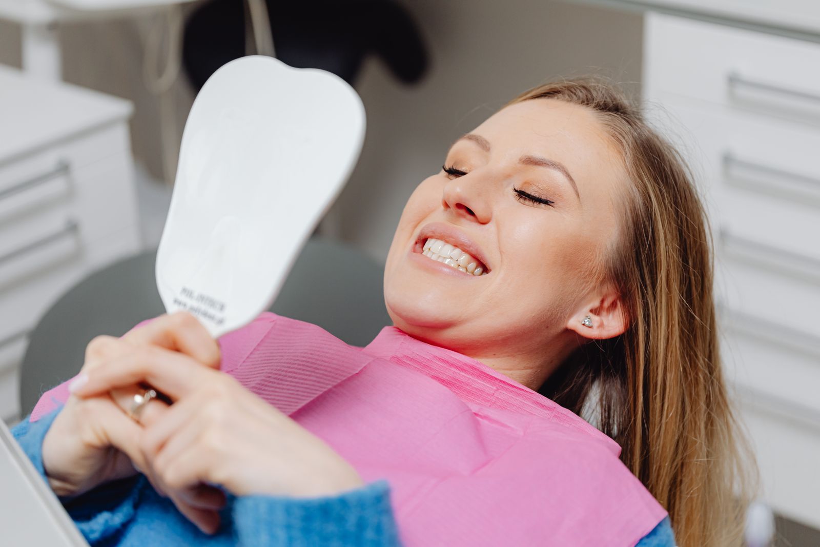 Dentist and patient smiling together in a dental clinic