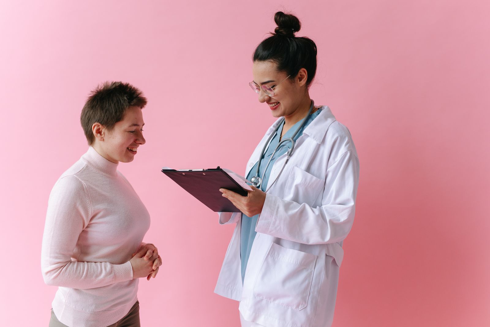 Doctor consulting with a smiling patient in a clinic
