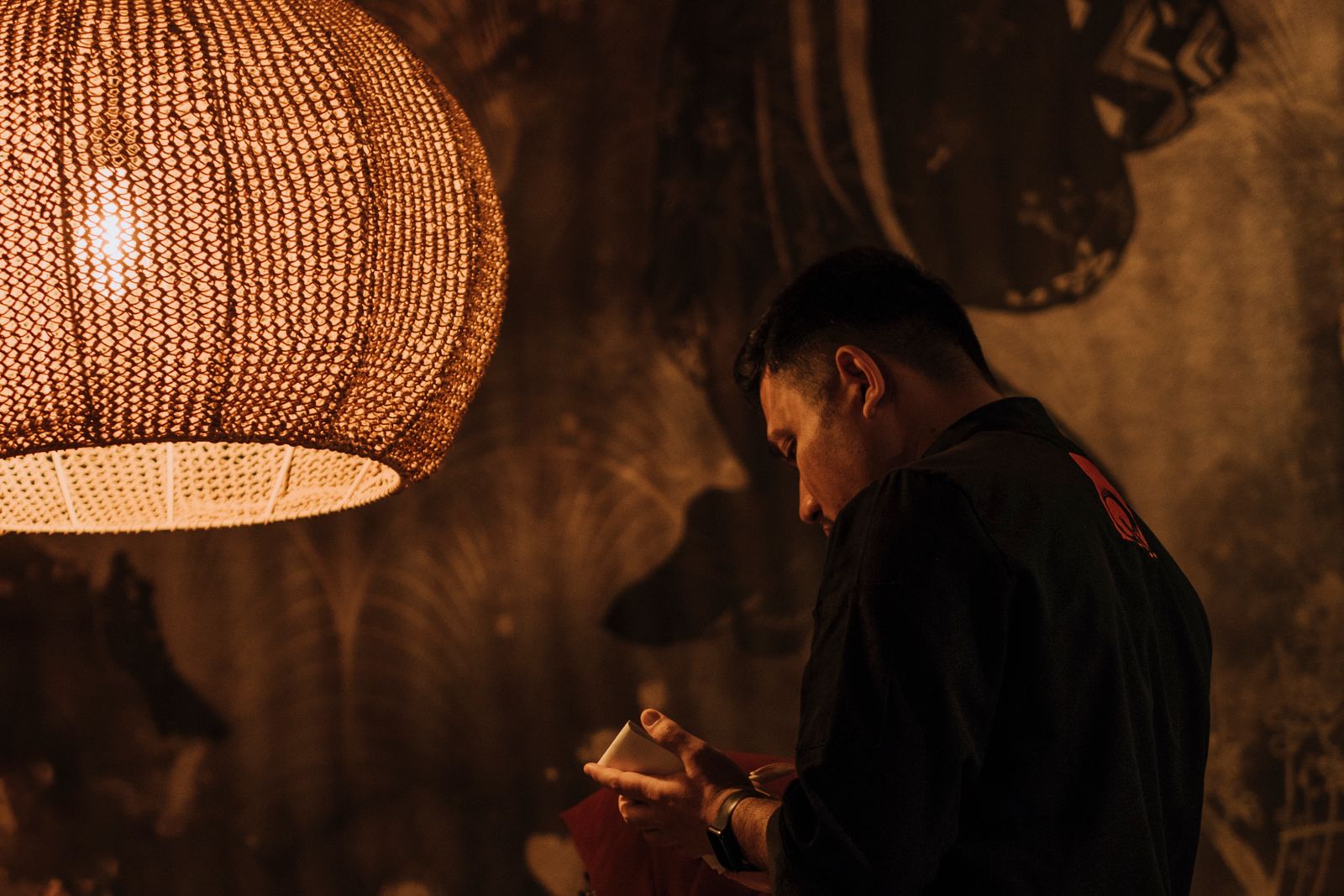Waiter serving a table of happy restaurant guests